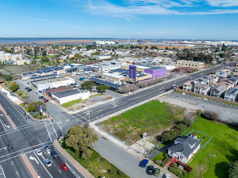 Aerial views of Central Avenue area showing open lots, residential housing, parking, and infrastructure near a major intersection and transit corridor.