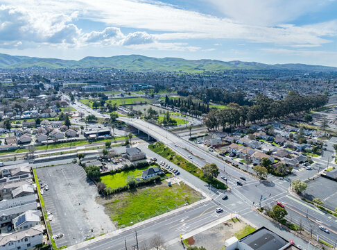 Aerial views of Central Avenue area showing open lots, residential housing, parking, and infrastructure near a major intersection and transit corridor.