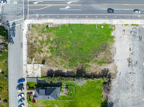 Aerial views of Central Avenue area showing open lots, residential housing, parking, and infrastructure near a major intersection and transit corridor.