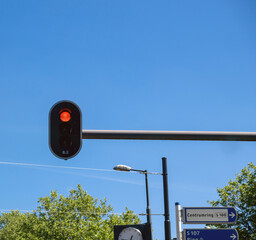 Red traffic light for cars, blue sky and Dutch text sign meaning Center ring. Netherlands