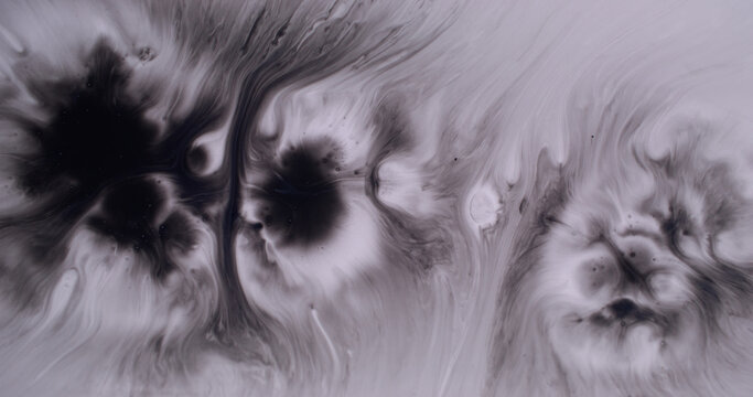 Paint stain. Splatter splotch. Black dye dripping on white enamel. Monochrome art explosion water abstract defocused background.