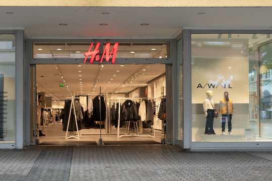 Neuwied, Germany - October 9, 2024: H&m store entrance displaying winter collection with mannequins