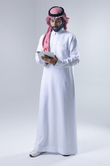 A collection of images of an Arab man wearing traditional Saudi thobe and shemagh, reflecting modern lifestyle activities like using technology, shopping, and standing confidently in a studio setting.