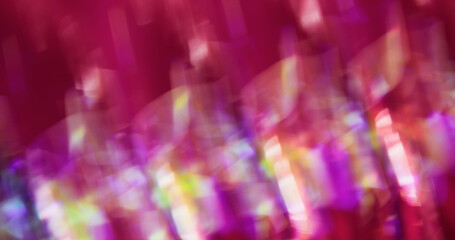 Defocused glow. Color light flare. Pink red purple lens on blurred art radiant bokeh crystal abstract background.