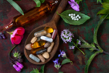Natural supplements and herbs on a wooden spoon