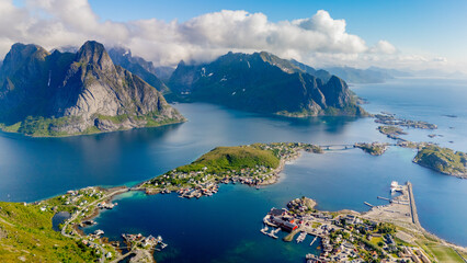 Lofoten Islands in Norway provide a stunning backdrop of majestic mountains rising from tranquil...