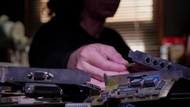A close-up shot of the intricate components of a graphics card, including a large heat sink with cooling fins and visible capacitors and circuits on the printed circuit board