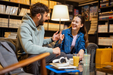 Smiling Friends Enjoying Coffee and Conversation at Library Café