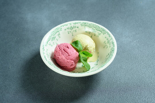 two scoops of ice cream in a bowl 