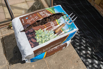 Garden fork on a bag of wood bark