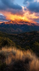 Golden sunrise over mountains, with shifting clouds adding depth to the scene. Vertical.