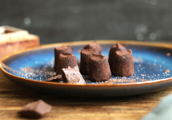 truffle candies in a plate on a wooden table