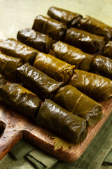 dolma, minced meat with rice, in grape leaves, minced meat rolls, on a chopping board, top view, no people,