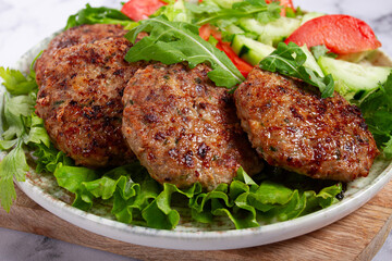 Fried cutlets, mixed minced meat, with vegetable salad, homemade, top view, no people,