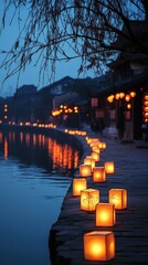 Glowing lanterns line a quiet riverbank, adding charm to the festival display. Vertical.