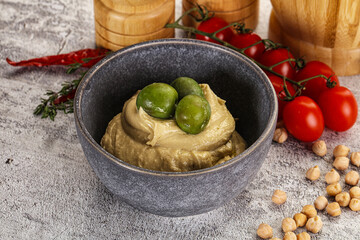 Tasty hummus with green olives