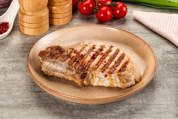 Grilled pork loin steak with bone