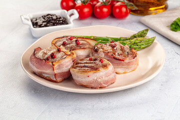 Tasty grilled pork medallion with bacon