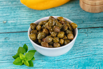 Pickled canned capers in the bowl