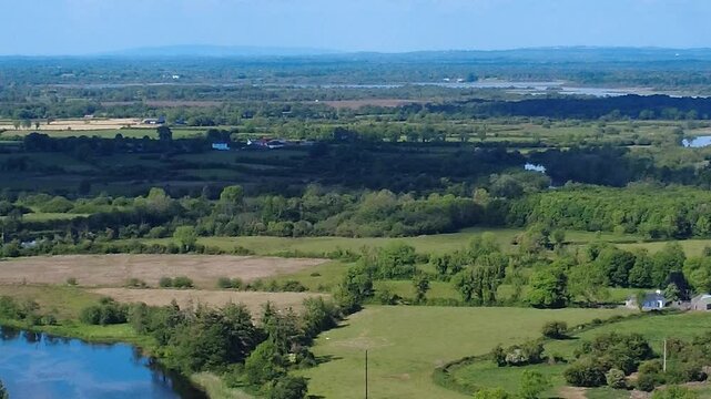 The lush green fields and distant hills of County Roscommon, Ireland and the lifting bridge at Tarmonbarry showcasing the picturesque countryside.