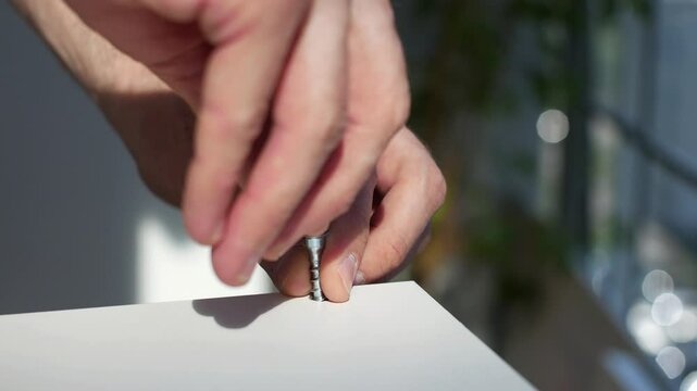 Close-up of a furniture assembler at work