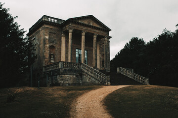 a temple in a scenic English garden