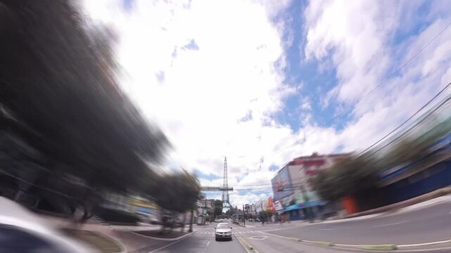 Torre del Reformador, Guatemala City | filmed from moving car with low-angle and distant views, dynamic truck-style motion and light blur