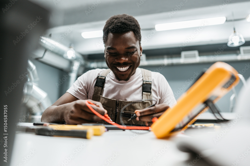 Poster skilled technician working with tools in a workshop environment during the day, showing enthusiasm a
