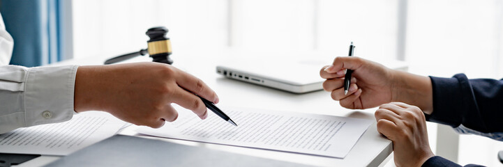 serious courtroom lawyer preparing litigation documents for business client before official hearing