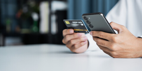 male using smartphone and credit card to complete secure digital payment and banking transaction online