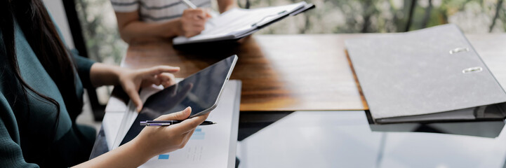 Business administrator reviewing financial reports and marketing analysis for company sales growth and strategy development