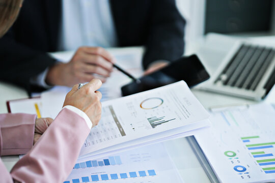 Business administrator evaluating marketing and sales data for improved business growth and financial results at office