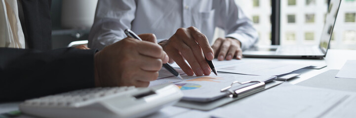 Business administrator evaluating marketing and sales data for improved business growth and...