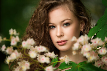 Naklejka premium Portrait of beautiful young girl in park in spring