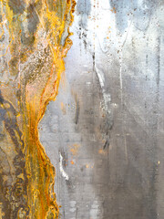 A close up of a painting with a gray and yellow background, rust on metal