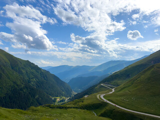 A scenic road through a picturesque valley with majestic mountains