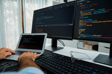 Cropped typing hands photo in IT developer working software development coding on laptop with...