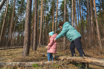 grandmother with granddaughter walking and playing in nature in the forest