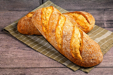 Rustic bread loaves on checkered cloth