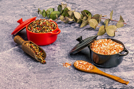 Himalayan pink salt and mixed peppercorns on marble surface