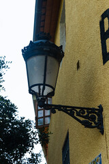 Classic metal lamp attached to textured wall. Suitable for architecture, urban design, or...