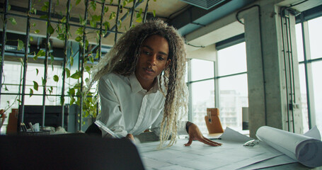 Businesswoman working remotely with laptop open