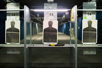 Indoor shooting range featuring targets on multiple lanes for practicing shooting skills Advanced...