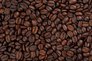 Texture of roasted coffee beans as background, top view. Freshly Arabica coffee beans.
