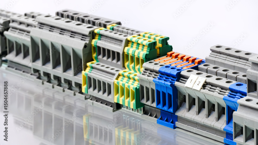 Poster A row of electrical connectors with different colors and sizes. Concept of organization and variety, as the connectors come in different shapes and colors. Scene is one of technical precision
