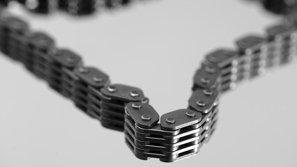 Close-up of car engine timing chain links, car service concept background.