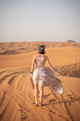 Beautiful girls in a beautiful flowing dress in desert condition