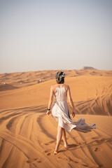 Beautiful girls in a beautiful flowing dress in desert condition