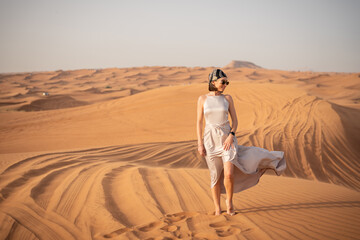 Beautiful girls in a beautiful flowing dress in desert condition