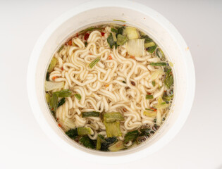 Dry instant noodles in cup isolated. Raw spaghetti in a plastic cup, fast food pasta in container